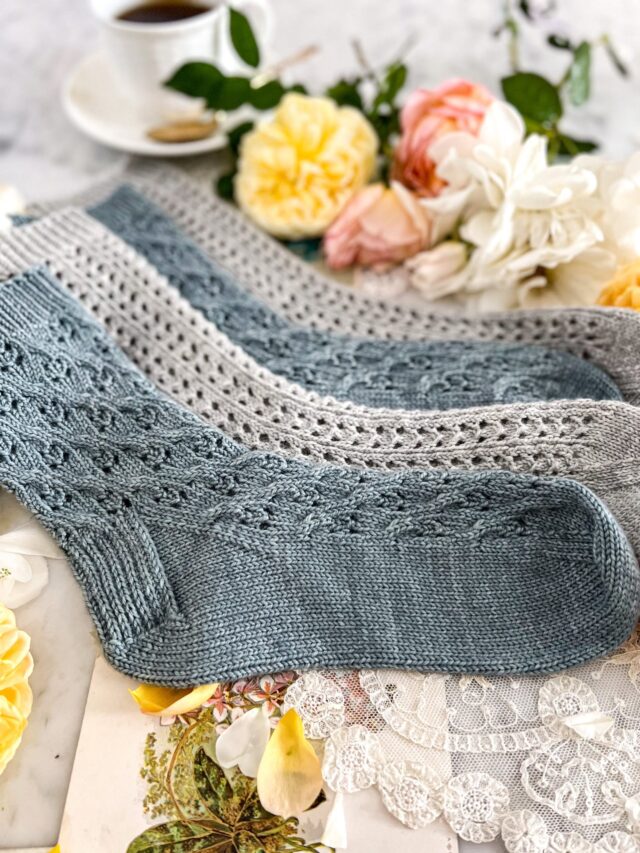 Four socks, stacked on each other in alternating blue and gray, photographed from the heel.