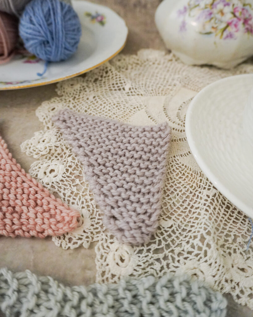 A close-up on a pale purple mini shawl. This shows an asymmetrical triangle construction with one increase at the end of each right side row only.