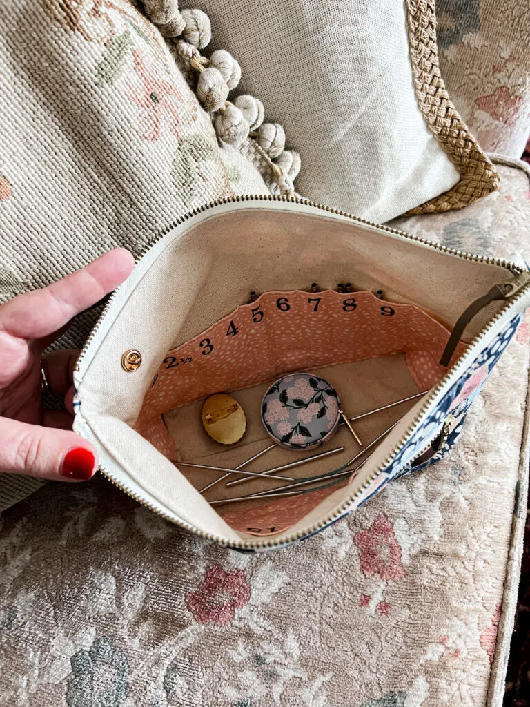 A peek at the inside of a specially designed organizer for interchangeable needle sets. Inside the zippered pouch are numbered spots for each size of needle tip.