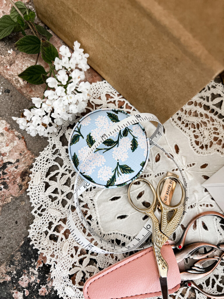 A close-up on a retractable measuring tape with a floral case.