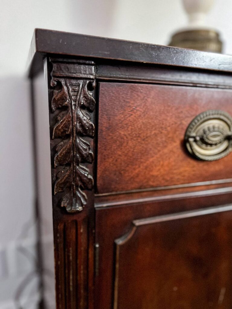 A close-up of the carved detail on the corner of a vintage credenza I found on Craigslist.