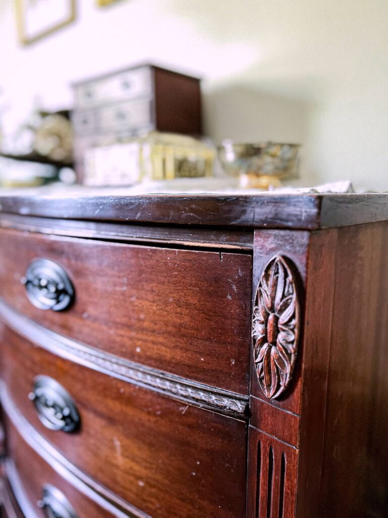 A close-up of the carved details on a vintage dresser I found on Facebook Marketplace.