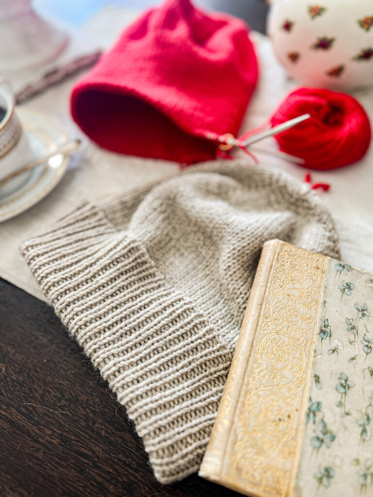 A close-up on the folded-over ribbed brim of a tan knit hat.